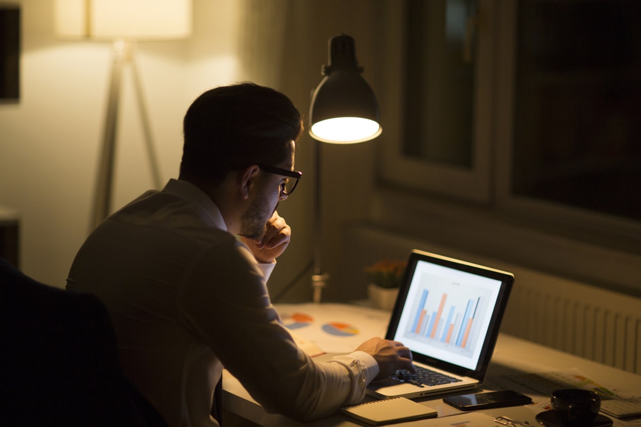 Man working with laptop late at night at home