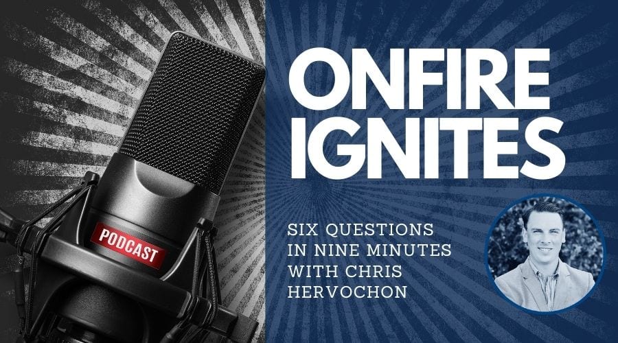 Podcast microphone next to Onfire Ignites with Chris Hervochon's photo