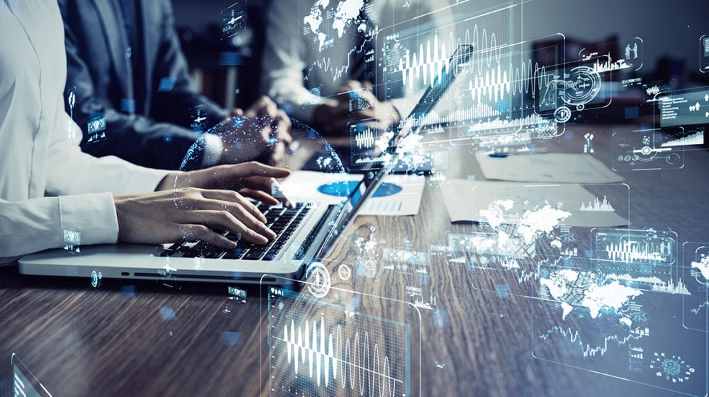 Business people at laptops sitting at a table