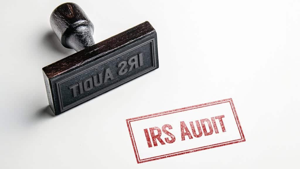 A stamp sitting on its side with IRS Audit in red stamp