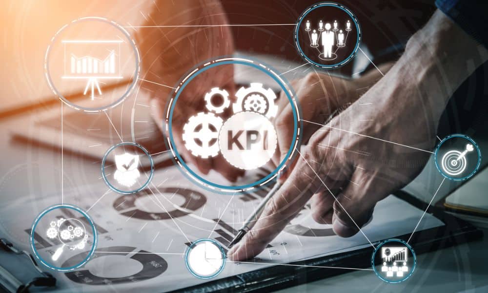 A hand pointing to a paper with graphs. Icons floating around one that says KPI